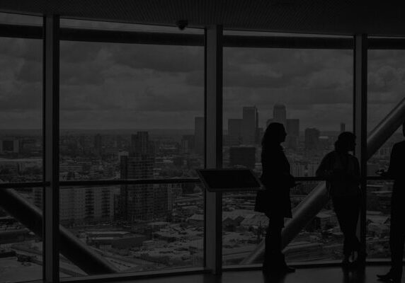 Silhouettes in front of cityscape
